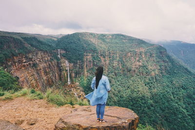 Woman overlooking countryside landscape