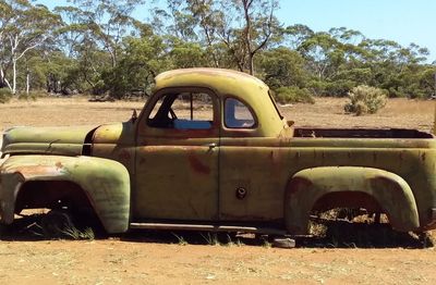 Abandoned car on field