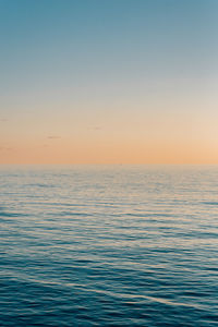 Scenic view of sea against clear sky during sunset