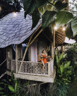 Man sitting by built structure