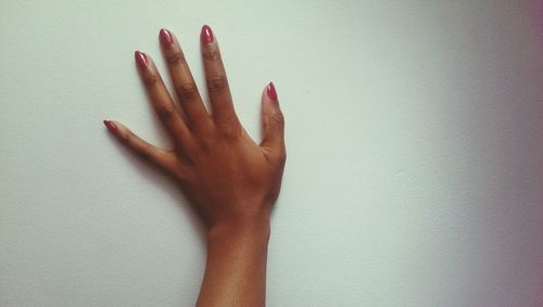 Cropped image of woman hand over white background