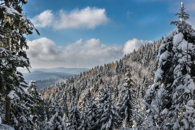 View of snowcapped mountains against cloudy sky