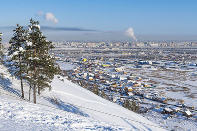 Aerial view of townscape against sky during winter