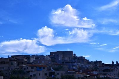 Low angle view of buildings in town against sky