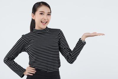 Portrait of a smiling young woman over white background