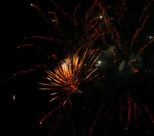 Low angle view of firework display at night