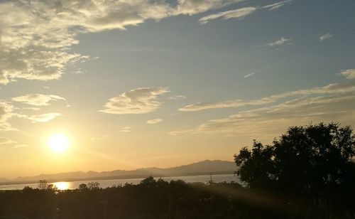 Scenic view of silhouette mountains against sky at sunset