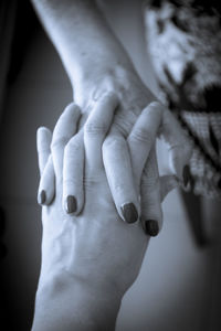 Close-up of women holding hands