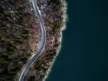 High angle view of road amidst trees and sea