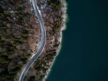 Aerial view of road by river against sky