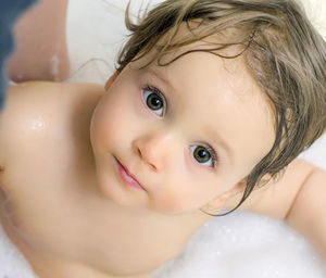 Portrait of cute baby girl in bathroom