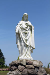 Low angle view of statue against sky