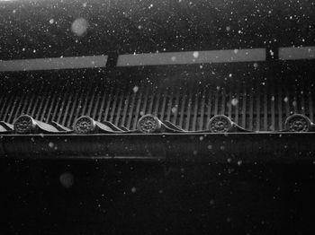 Low angle view of roof during snowfall