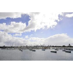 View of harbor against cloudy sky