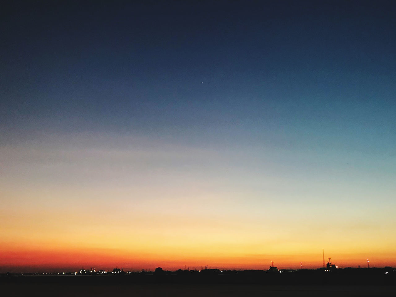 SILHOUETTE LANDSCAPE AGAINST CLEAR SKY AT SUNSET