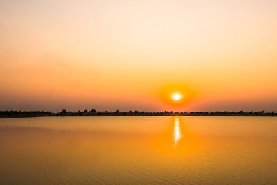 Scenic view of lake against romantic sky at sunset