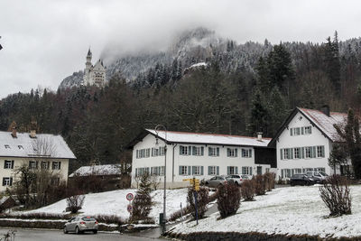 Houses against sky during winter