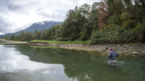 High angle view of man in lake against sky