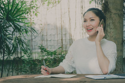Portrait of a smiling young woman holding umbrella