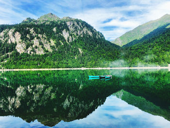 Scenic view of lake and mountains against sky