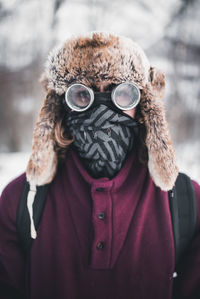 Close-up portrait of man standing in snow