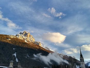 Low angle view of snowcapped mountain against sky