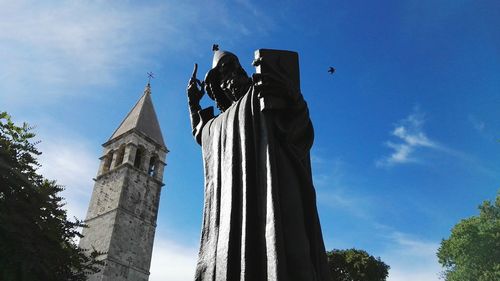 Low angle view of statue against sky