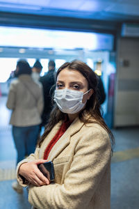 Portrait of woman standing in snow