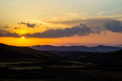 Scenic view of silhouette mountains against sky during sunset