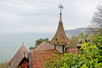 View of roofed structures overlooking sea