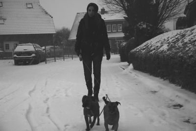 Man with dog walking in snow