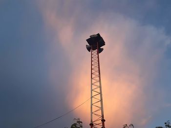 Low angle view of communications tower against sky during sunset