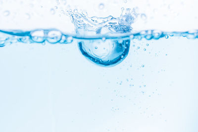Close-up of water splashing against white background