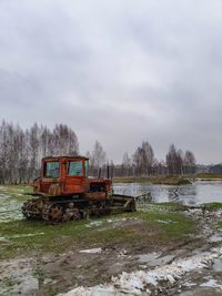 Built structure by river against sky