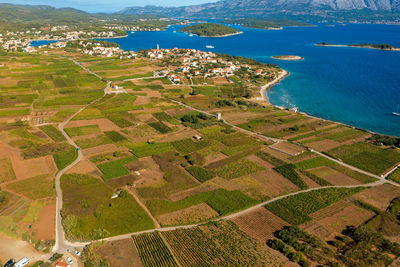 High angle view of agricultural field by sea