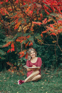 Portrait of smiling girl sitting on land