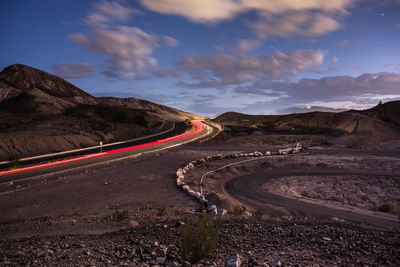 High angle view of light trails on road against sky at night