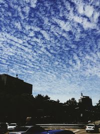 Cars on road with buildings in background