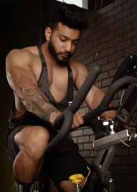 Portrait of young man exercising in gym