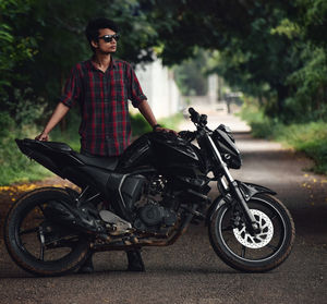 Young man riding motorcycle on road