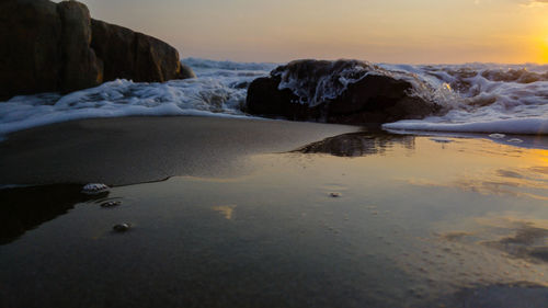 Scenic view of beach against sky during sunset