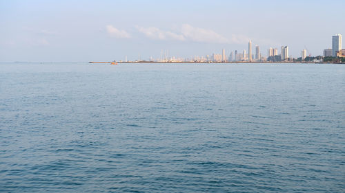 Scenic view of sea and buildings against sky