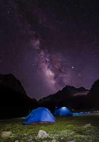 Tent on field against sky at night