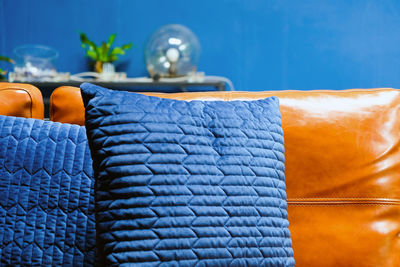 Close-up of blue cushions on sofa at home