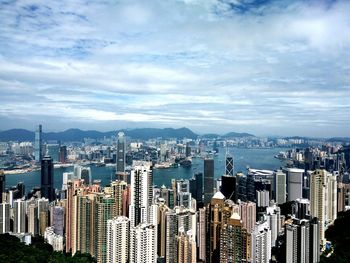 High angle view of cityscape against cloudy sky