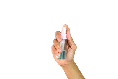 Close-up of hand holding hands against white background