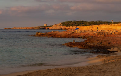 Scenic view of beach against sky during sunset