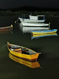 Yellow boat moored on lake