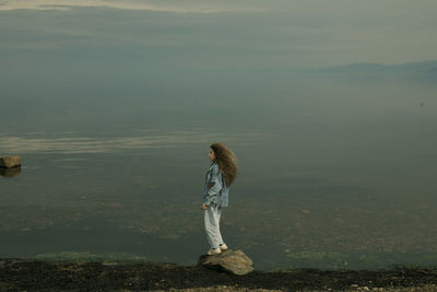 Full length of man standing on riverbank