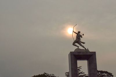 Low angle view of angel statue against sky